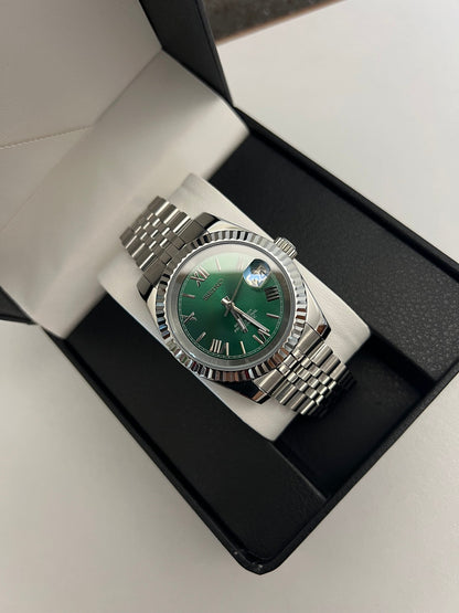 Datejust (Green Roman) Seiko NH35 automatic mod watch. A watch in a box shows a green dial with a silver fluted bezel and a silver jubilee bracelet.