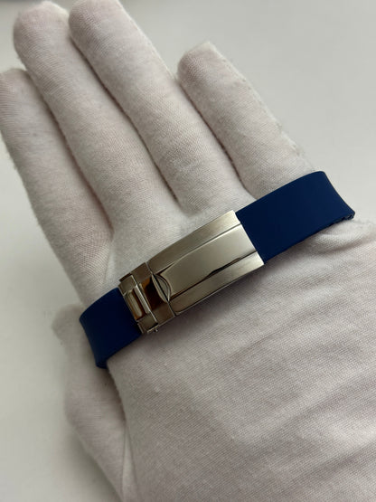 Speedmaster (Blue) Seiko VK63 meca-quartz chronograph mod watch. A detail shot showing the underside of a blue rubber watch strap with a silver metal deployment clasp.