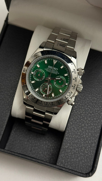 Daytona (Green) Seiko VK63 meca-quartz chronograph mod watch. A green dial watch with a silver bezel and metal link bracelet inside an open black display box.