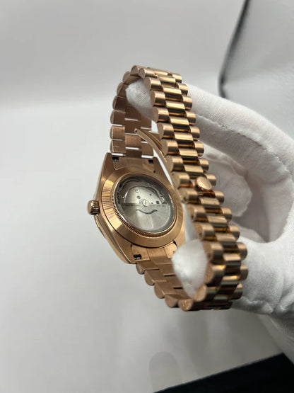 Day-Date (Rose Gold, Green) Japanese automatic mod watch. A caseback detail shows the back of the rose gold watch with a clear window revealing the movement.