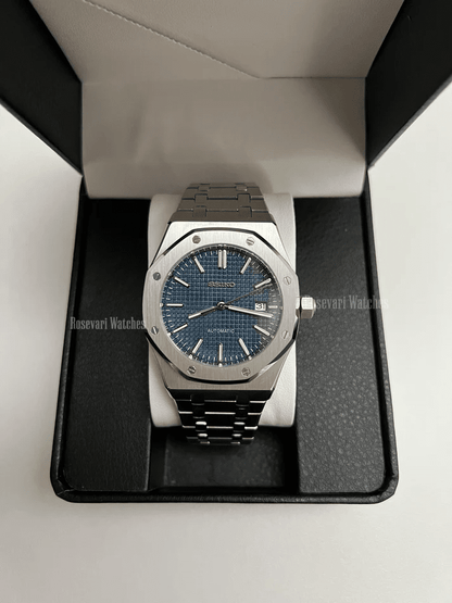 Royal Oak (Blue) Seiko NH35 automatic mod watch. A full watch shot inside a box showing a blue textured dial and silver bezel on a metal link bracelet.