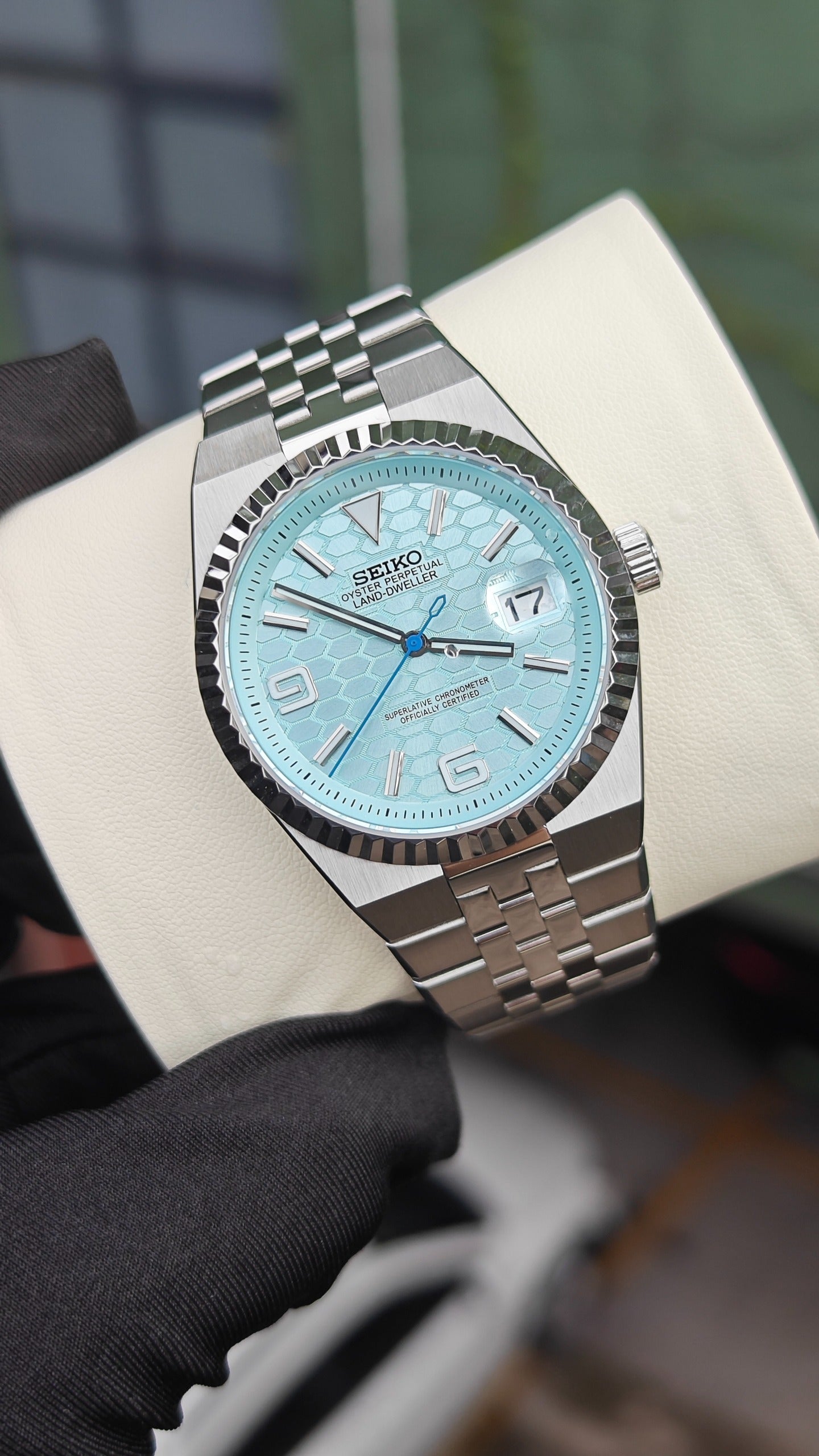 Land-Dweller (Tiffany) Seiko NH35 automatic mod watch. A light blue honeycomb dial watch with a silver fluted bezel and jubilee bracelet in a full view.