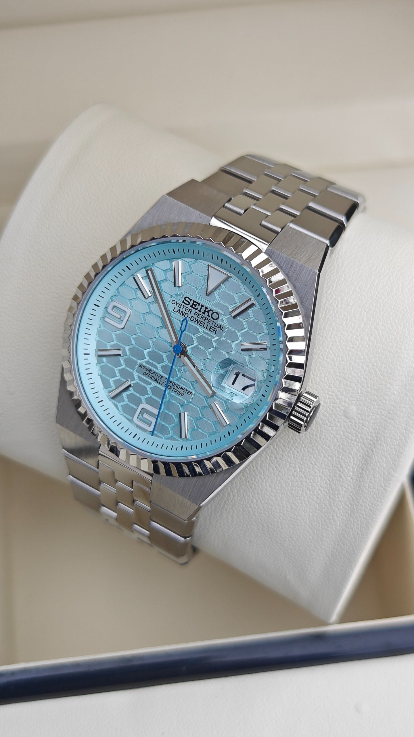 Land-Dweller (Tiffany) Seiko NH35 automatic mod watch. A light blue honeycomb dial watch with a silver fluted bezel and jubilee bracelet in a full view.