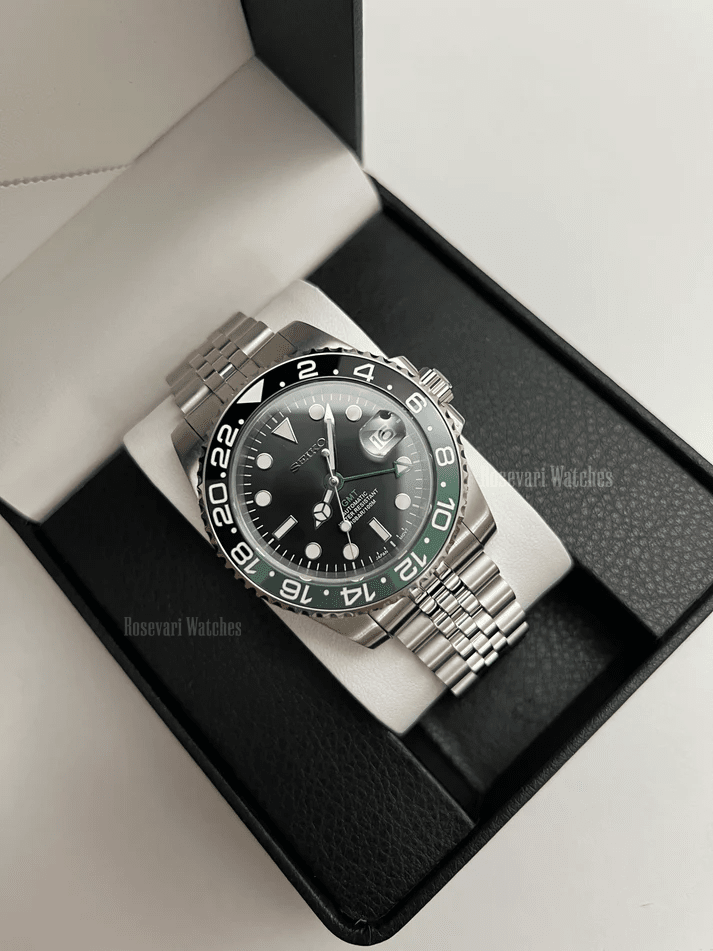 GMT (Sprite) Seiko NH34 GMT automatic mod watch. A full watch with a black dial and a black bezel on a jubilee bracelet inside a watch box.