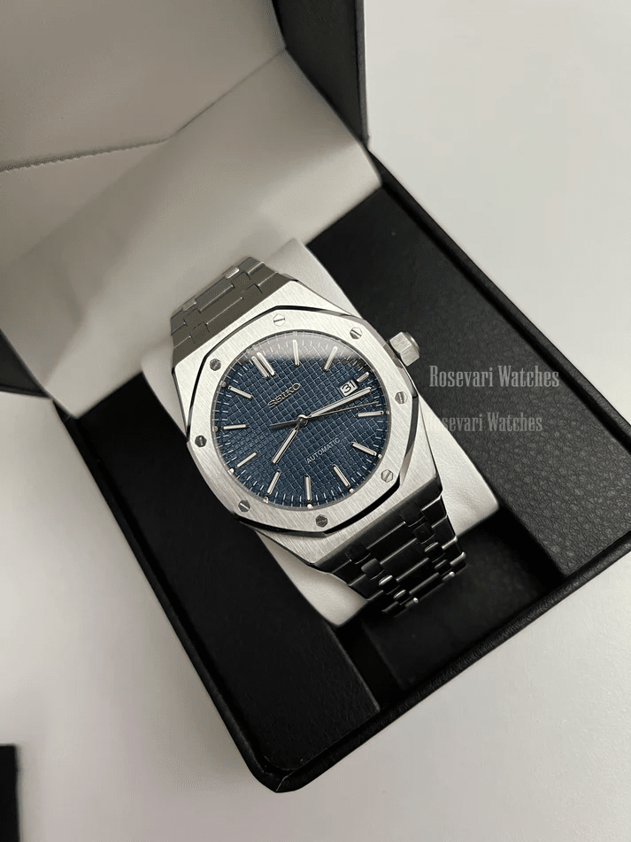 Royal Oak (Blue) Seiko NH35 automatic mod watch. A full watch shot inside a box showing a blue textured dial and silver bezel on a metal link bracelet.