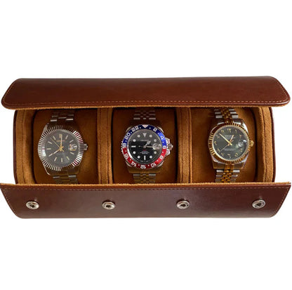 3 Piece - Watch Travel Case (Brown). An open brown leather watch roll displays three watches with metal bracelets in a studio shot.