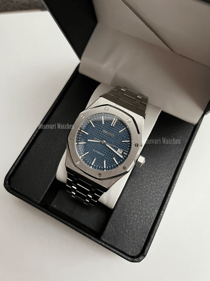 Royal Oak (Blue) Seiko NH35 automatic mod watch. A full watch shot inside a box showing a blue textured dial and silver bezel on a metal link bracelet.