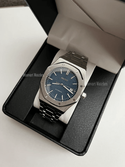 Royal Oak (Blue) Seiko NH35 automatic mod watch. A full watch shot inside a box showing a blue textured dial and silver bezel on a metal link bracelet.