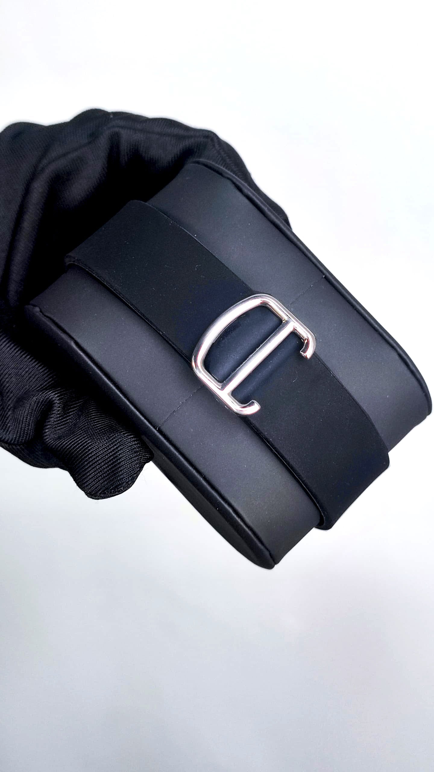 Santos (Black) Seiko NH35 automatic mod watch. A clasp detail shot showing a silver buckle on a black rubber strap.